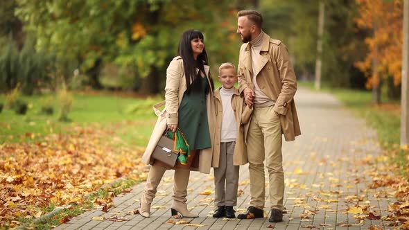 A Happy Family is Walking in the Park