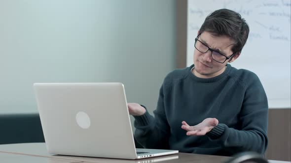 Young Boy Video Conferencing with Tutor on Laptop in School