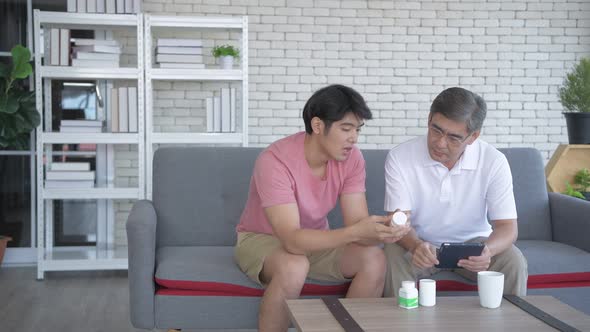 Family concept. Father and son are studying drug use information together. 4k Resolution.