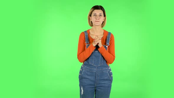 Female Stands Worrying in Expectation Then Smiles with Relief, Carried. Green Screen