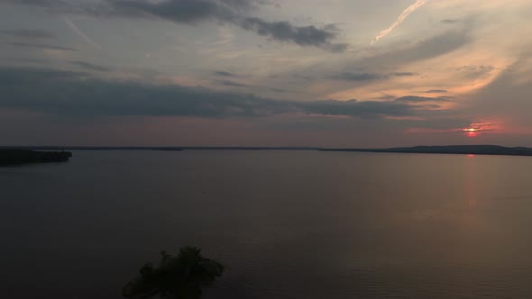 Late day aerial shot of body of water and pink sunset in Canada