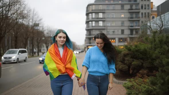 Two Cheerful Lesbian Women Walk Towards Camera