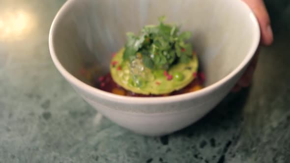 Chef is Making Seafood Tartar Poke Bowl Salmon Avocado Tuna Atappetizer on Professional Kitchen