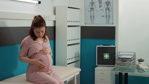 Portrait of Pregnant Patient Waiting for Doctor to Attend Physical Examination