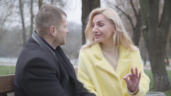 Charming Blond Caucasian Woman Talking Emotionally with Adult Man and Smiling. Portrait of Loving