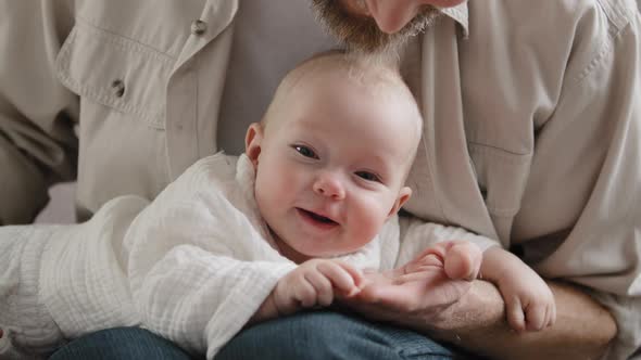 Caucasian Bearded Man Father Daddy Tickling Baby Head with Beard Playing with Kid Little Daughter