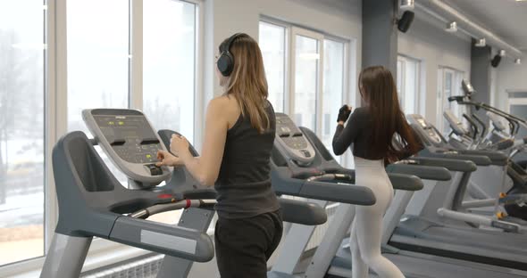 Women Going on Treadmills at Modern Gym