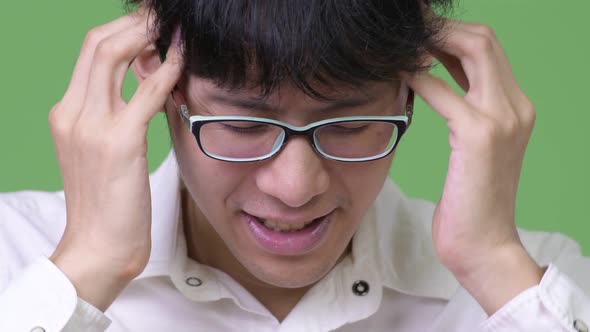 Young Asian Businessman Having Headache