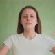 Young Woman Breathes Making Gestures to Calm Down on Green - VideoHive Item for Sale
