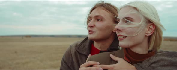 Joyous Couple Embracing on Autumn Field