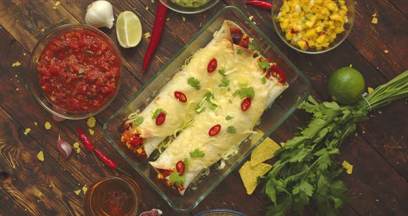 Vegetable Burritos Served in Glass Heatproof Dish. With Salsa, Guacamole, Nachos and Ingredients