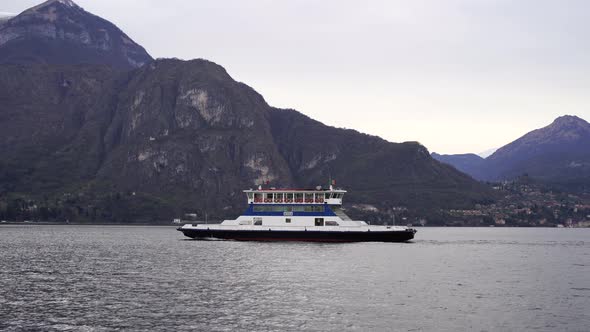 Ferry Floats on the Lake Against the Backdrop of Mountains