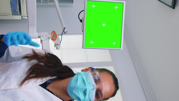 Vertical Video Patient Pov of Dentist Explaining Problem Using Greenscreen Monitor