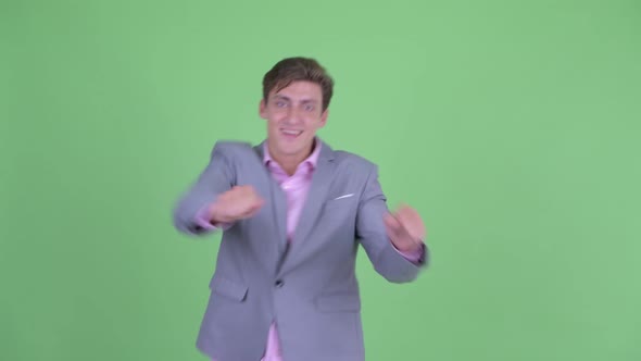 Happy Young Businessman Dancing and Having Fun