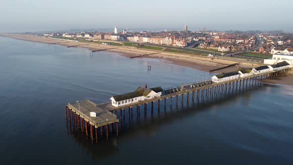 Southwold Pier in Suffolk and the town of Southwold just after Sunrise. Shot with a drone looking fr