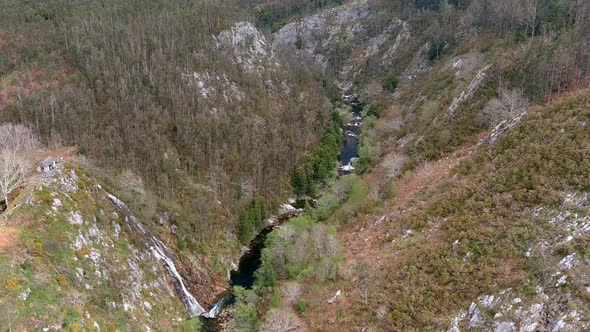 viewpoint and waterfall on the cliff of the River Sor with forests and fenced path that descends wit