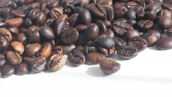 Slow tilt on roasted coffee beans close-up 4K  video