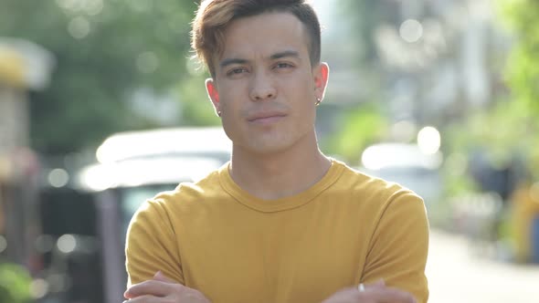 Face of Happy Young Asian Man Smiling Outdoors