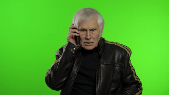 Elderly Stylish Caucasian Grandfather Man Dissatisfied Talking on Mobile Phone