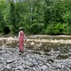 Vintage romantic woman in straw hat, long dress walks on river rocks near forest. Natural scenic - VideoHive Item for Sale