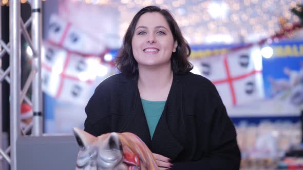 young woman at christmas time smiling and flirting with camera