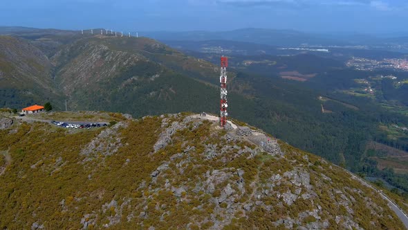 Aerial Circle Dolly View Of Telecommunications Mast On Rocky Hillside Viewpoint In Miradoiro da Curo