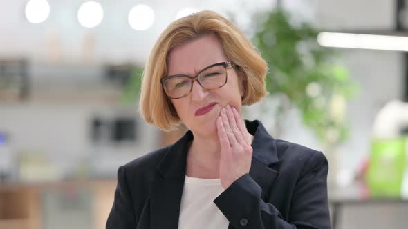 Portrait of Old Businesswoman Having Toothache 