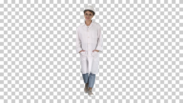 Woman in a white lab coat and hard hat walking, Alpha Channel