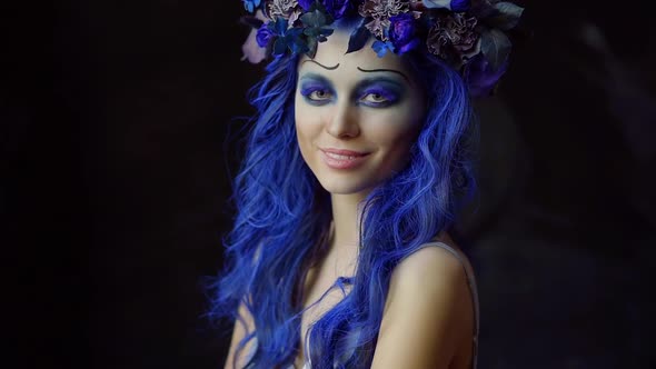 Close-up of Woman's Face with Stunning Halloween Corpse Bride Makeup Looking at Camera. Creative