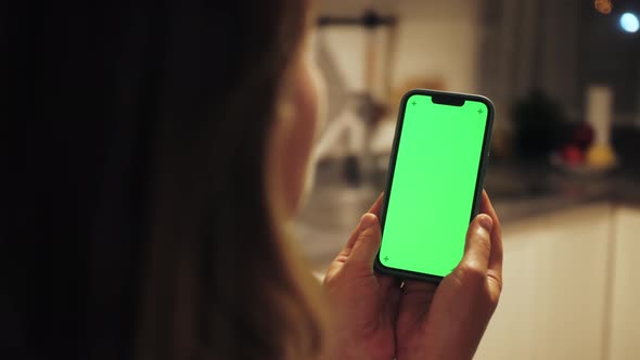 Closeup Shot of Green Screen Smartphone in Female Hands Girl Watching Content Without Touching
