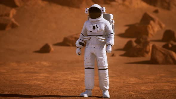 Astronaut on Mars Surface. Red Planet Covered in Gas and Rock