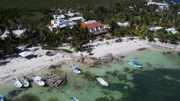 Aerial shot of boat sailing in the corner of the beach at Akumal, Tulum, Quintana Roo, Mexico. Woode