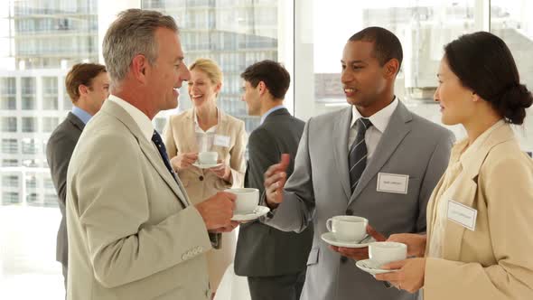 Business People Chatting at a Conference Having Coffee