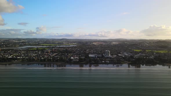 Flying sideways along the coast line of Orewa beach