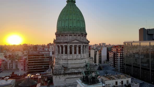 Aerial orbit of Argentine Congress Palace green bronze dome surrounded by Buenos Aires buildings at