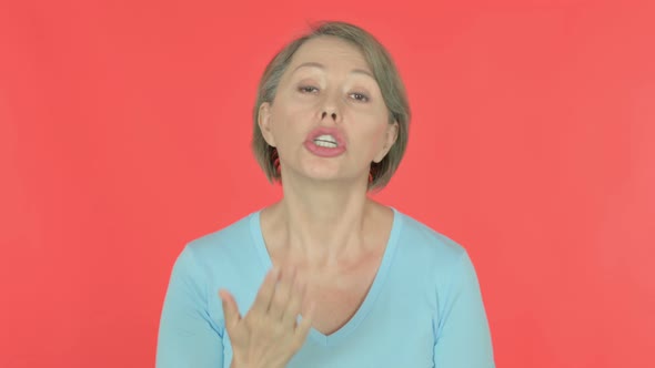 Angry Old Woman Arguing on Red Background