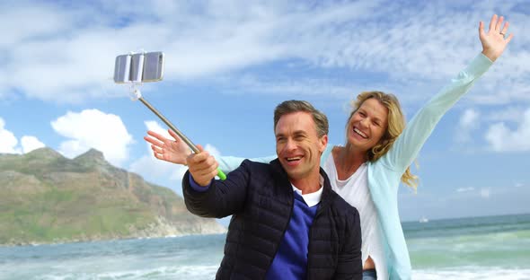 Mature couple taking a selfie from selfie stick