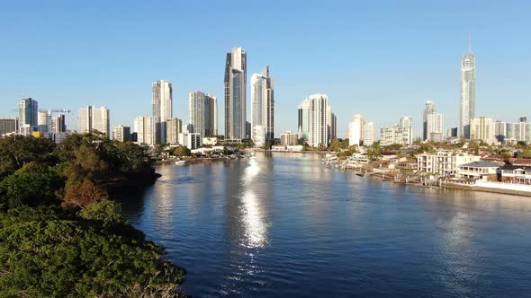 Ascending shot of Surfers Paradise approaching sunset, with beautiful reflection in water