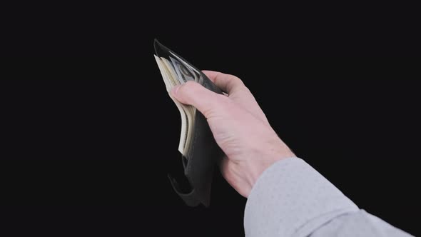 Male Hands Show a Black Wallet Full of 100 Dollar Bills on Alpha Channel