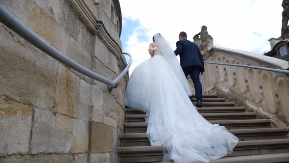 The Bride and Groom Climb the Stairs