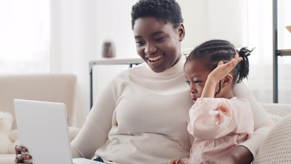 Portrait African Afro American Black Ethnic Mother Sitting on Sofa at Home Indoor with Cute Little