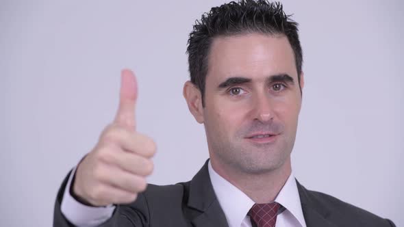 Face of Happy Handsome Businessman Giving Thumbs Up
