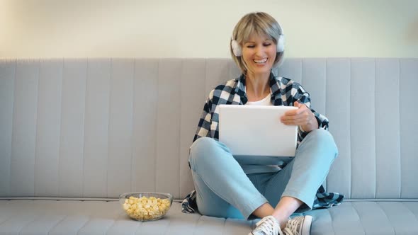 A Happy Beautiful Woman Enjoys and Laughs Merrily at a Funny Comic Comedy Movie While Watching It on