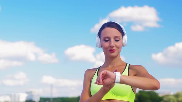 Woman with Headphones and Smart Watch Running