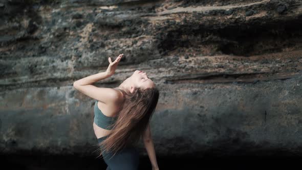 Portrait of Sensual Young Woman Looks at Camera and Moves Her Hands Smoothly