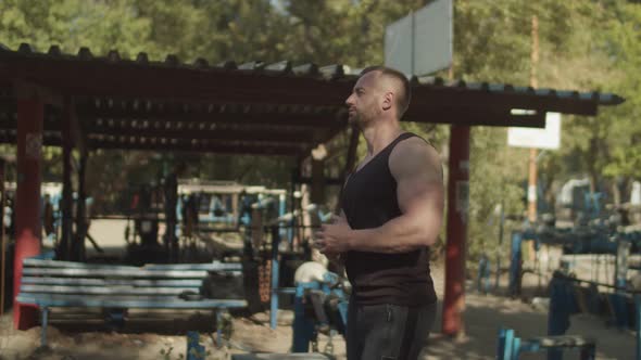 Strong Bodybuilder Getting Ready for Exercise