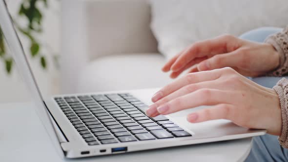 Cropped Shot of Female Hands Typing Text on Computer Keyboard Indoor Closeup Fingers of Caucasian