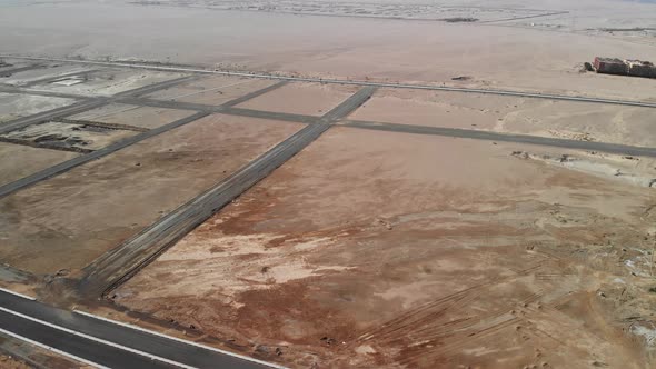 Flight over the desert in Egypt. Cars are driving far away