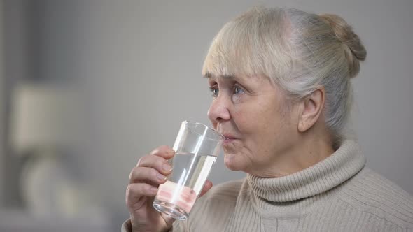 Upset Elderly Woman Drinking Water, Loneliness in Old Age, Nursing House