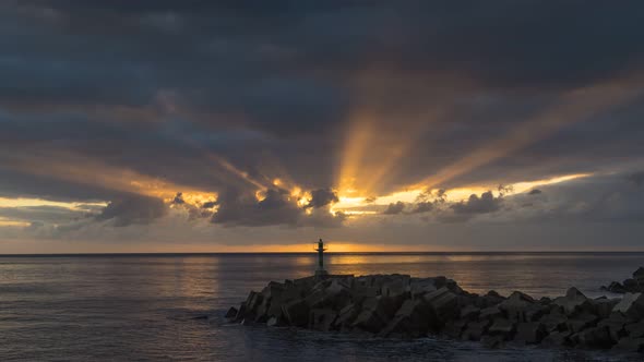 Sunset Timelapse of a Beach with a Small Lighthouse in Madeira Portugal